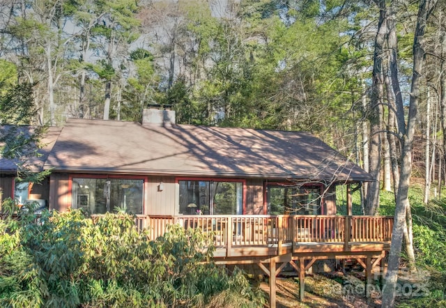 view of front of home featuring a deck and a chimney