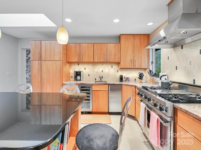 kitchen with island exhaust hood, light tile patterned floors, stainless steel appliances, decorative backsplash, and beverage cooler