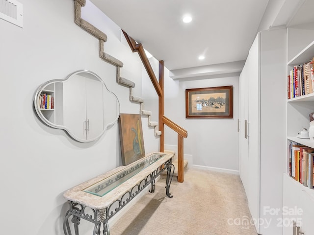 corridor with visible vents, baseboards, light colored carpet, stairs, and recessed lighting