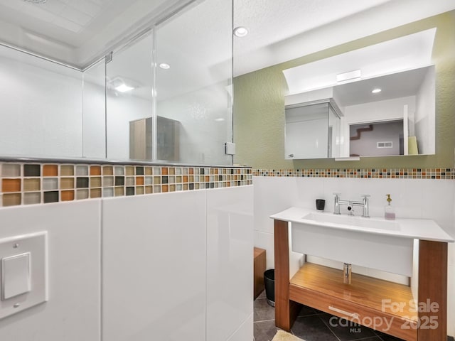 bathroom with recessed lighting, tile walls, decorative backsplash, and tile patterned floors