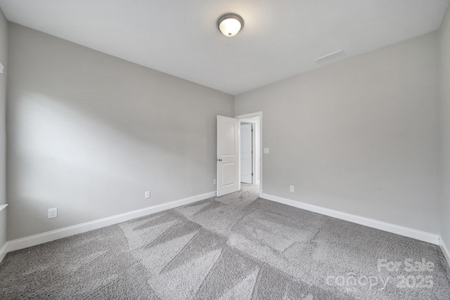 empty room with baseboards and carpet flooring