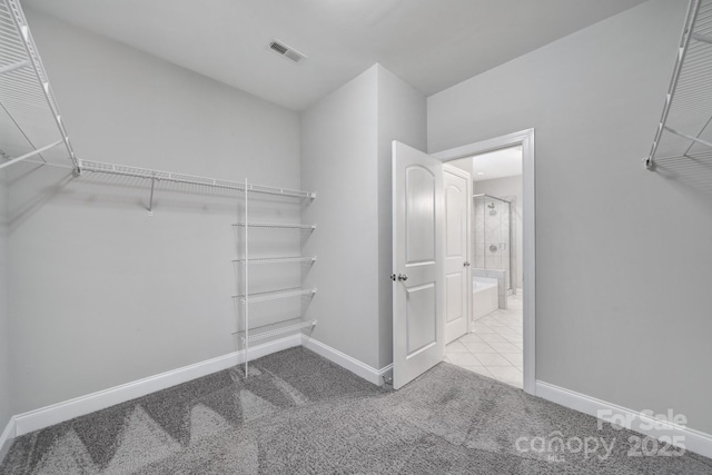 walk in closet featuring carpet floors and visible vents