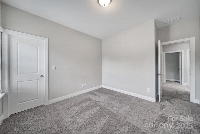 unfurnished room featuring carpet floors, baseboards, and visible vents