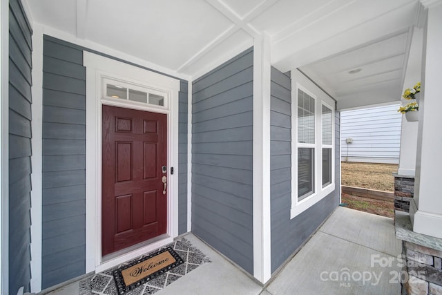 view of exterior entry with covered porch