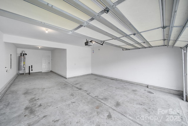 garage with a garage door opener, electric water heater, and baseboards