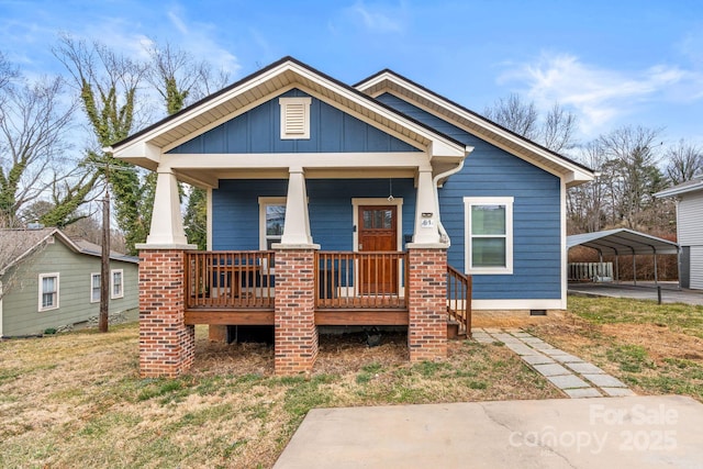 view of front of home featuring covered porch, a carport, crawl space, and board and batten siding