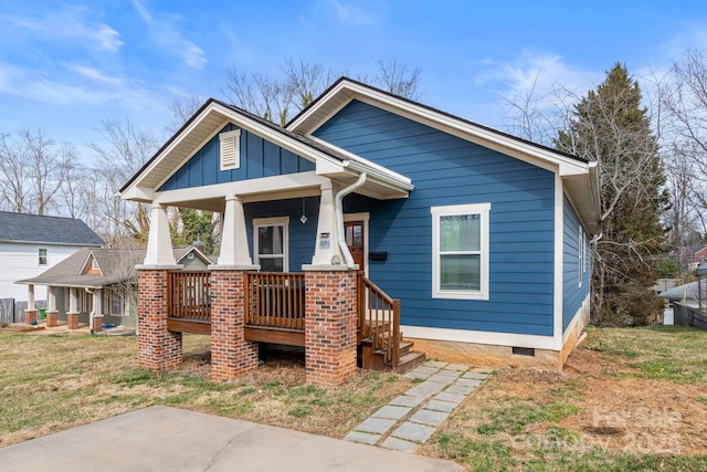 view of front of property with crawl space, covered porch, and board and batten siding