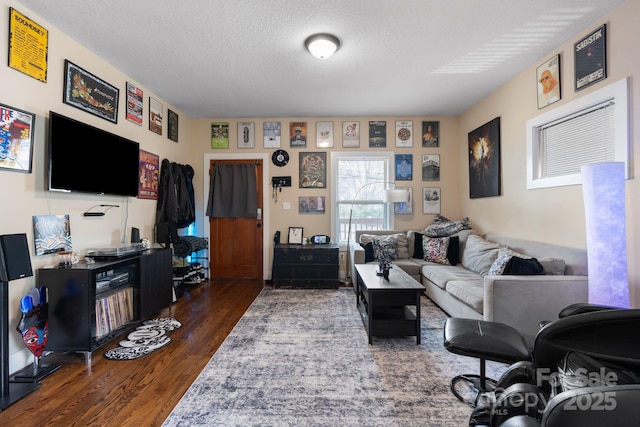 living room with dark wood-style flooring and a textured ceiling