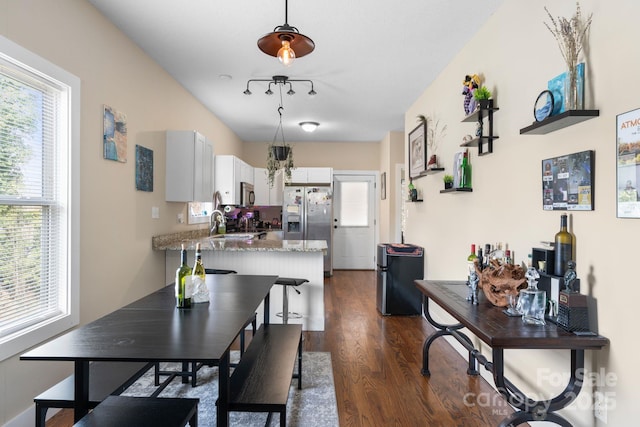 dining space with dark wood-type flooring