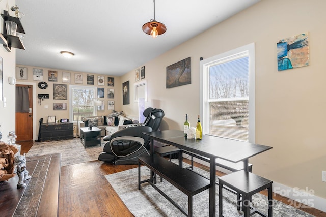 dining space with wood finished floors