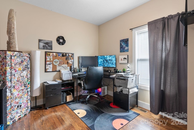 home office with wood finished floors and baseboards