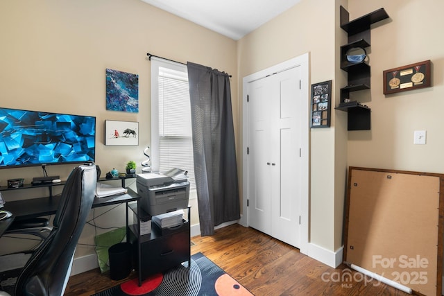 home office featuring baseboards and wood finished floors