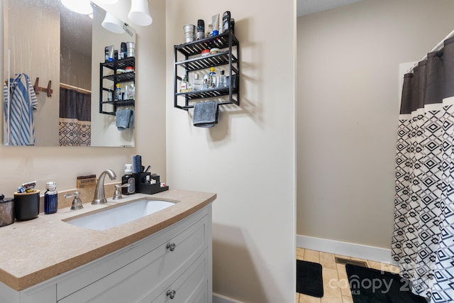 bathroom featuring visible vents, a shower with shower curtain, vanity, and baseboards