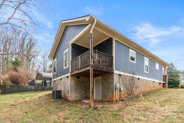 back of house with crawl space, a yard, and central AC unit