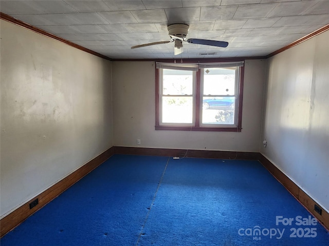 spare room featuring crown molding, baseboards, and ceiling fan