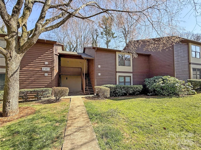 view of front of house with a front yard and stairs