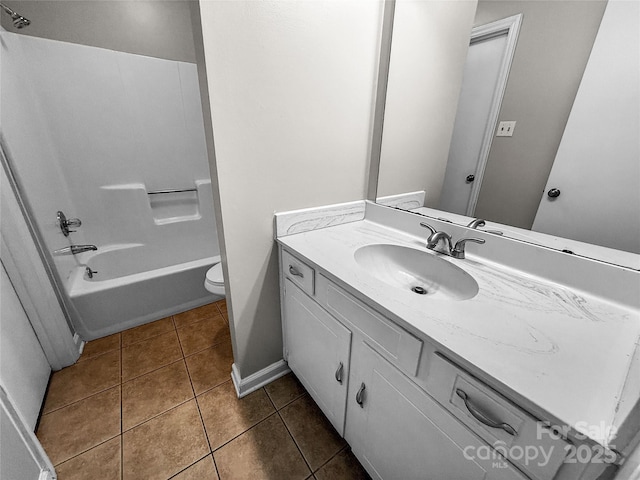 bathroom with bathing tub / shower combination, toilet, vanity, baseboards, and tile patterned floors