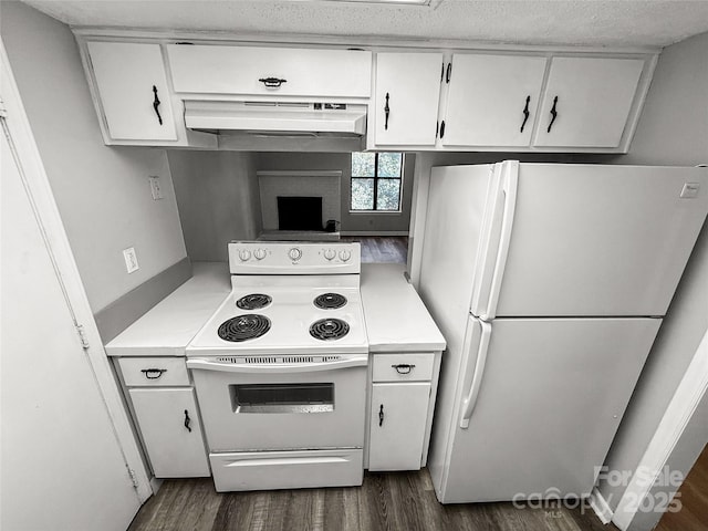 kitchen with under cabinet range hood, white appliances, dark wood-type flooring, white cabinets, and light countertops