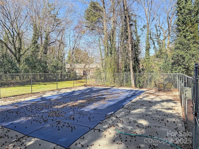 view of swimming pool featuring a gate and fence