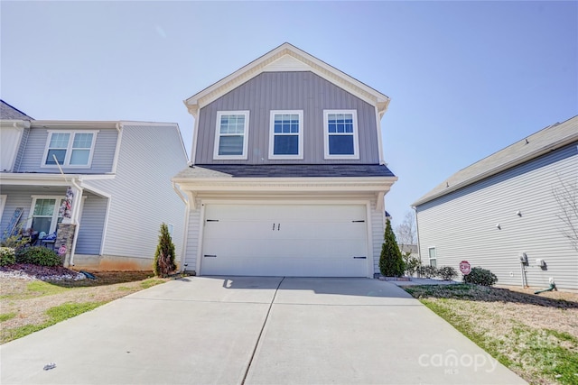 view of front of home with board and batten siding, driveway, and a garage