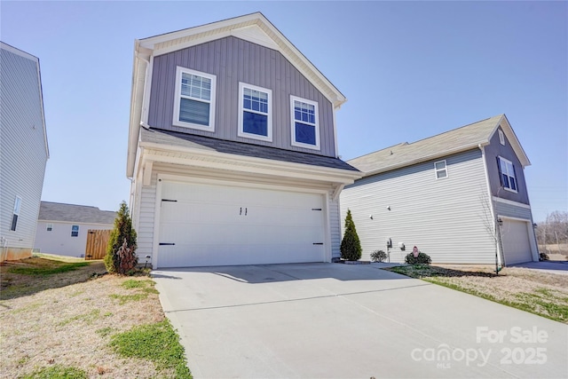 traditional home featuring a garage, board and batten siding, and concrete driveway