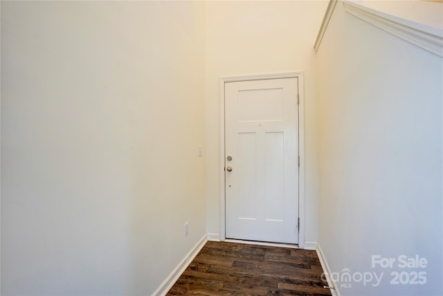 doorway to outside with baseboards and dark wood-style flooring