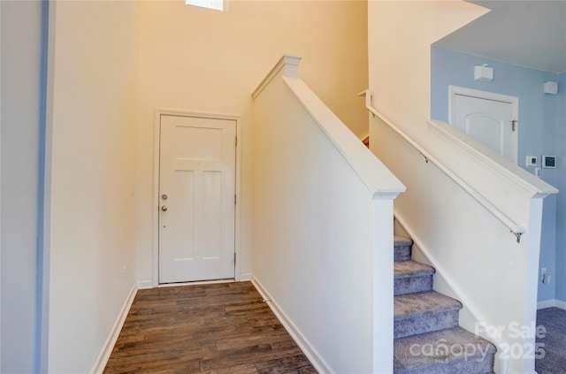 stairs with baseboards and wood finished floors