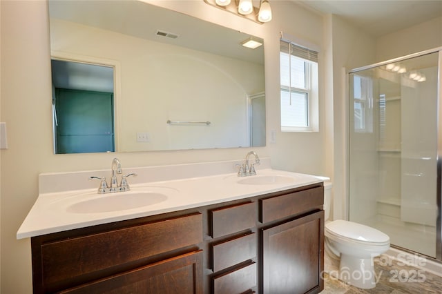 full bath with visible vents, a shower stall, and a sink