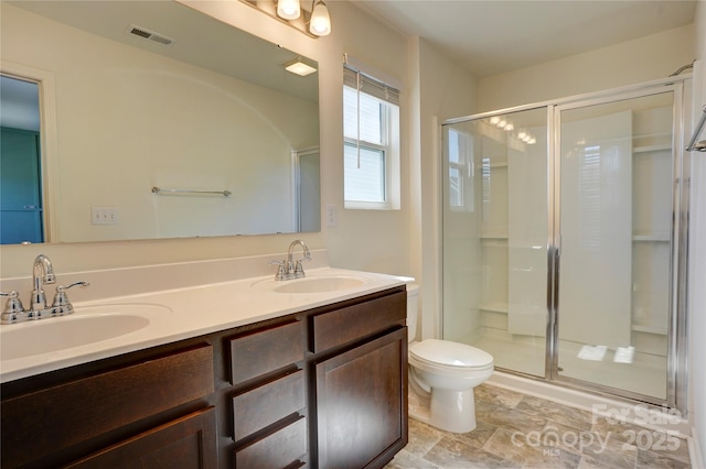 bathroom featuring a shower stall, visible vents, and a sink