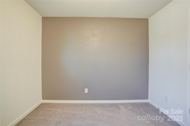 empty room with baseboards and light carpet