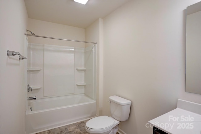 bathroom featuring toilet, vanity, and washtub / shower combination