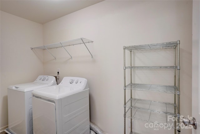 laundry room featuring laundry area and washing machine and clothes dryer