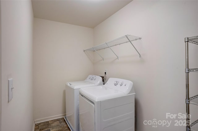 laundry area with laundry area, baseboards, independent washer and dryer, and stone finish flooring