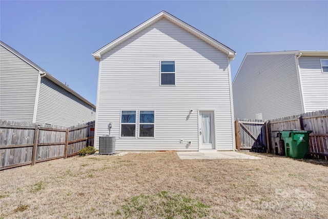 back of property featuring a yard, a patio, central AC unit, and a fenced backyard