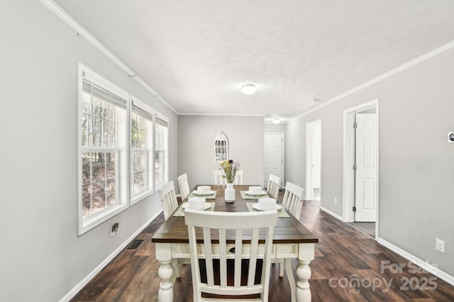 dining room with dark wood finished floors, visible vents, ornamental molding, a textured ceiling, and baseboards