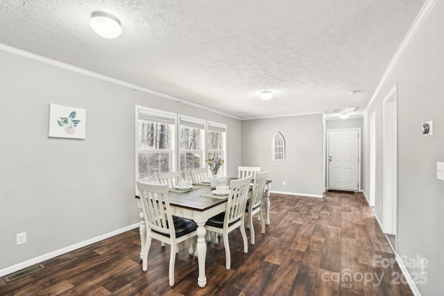 dining room with dark wood-style floors, visible vents, and ornamental molding