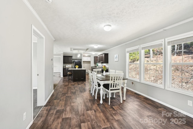 dining room featuring baseboards, dark wood finished floors, and crown molding