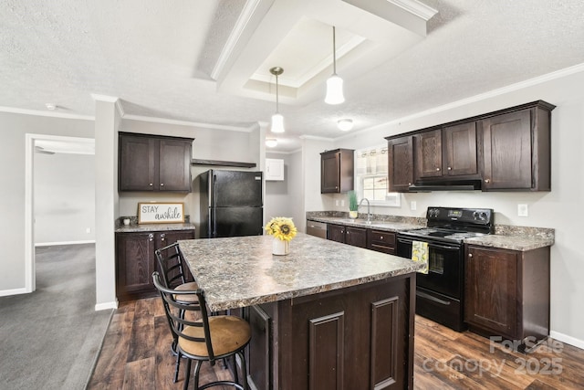 kitchen with a center island, decorative light fixtures, dark brown cabinets, and black appliances