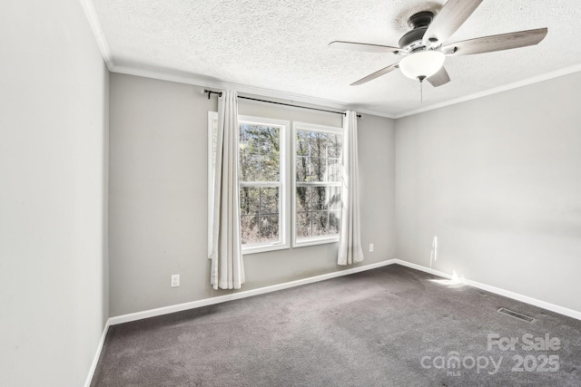 empty room featuring a textured ceiling, dark carpet, visible vents, and crown molding