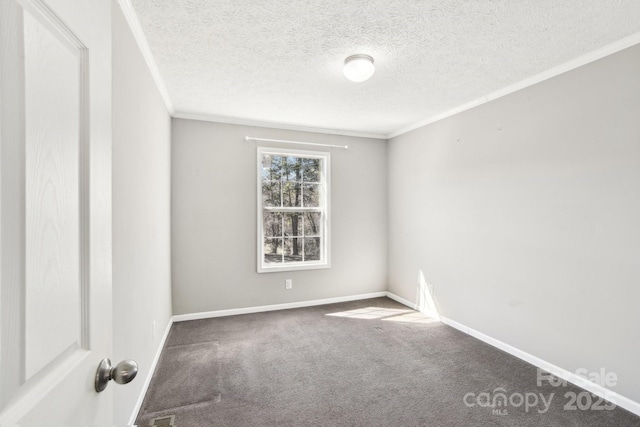 carpeted spare room with baseboards, a textured ceiling, and ornamental molding