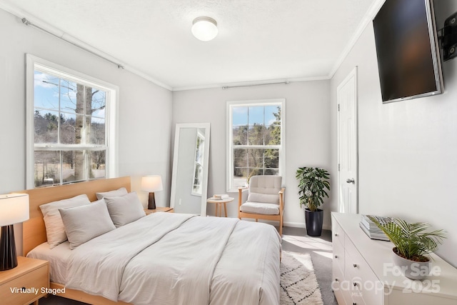 bedroom with ornamental molding and baseboards