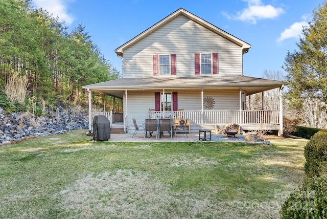 rear view of property with a patio area and a lawn