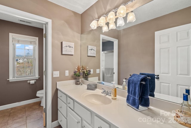 full bathroom with tile patterned flooring, toilet, vanity, baseboards, and a stall shower