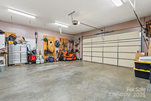 garage featuring a workshop area and a garage door opener