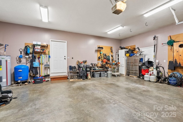 garage featuring a workshop area, electric water heater, and a garage door opener