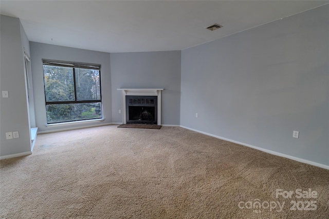 4814 Spring Lake Dr E, Charlotte, NC 28212 - unfurnished living room with carpet floors, visible vents, a fireplace with raised hearth, and baseboards