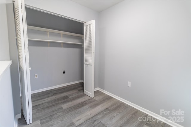 4814 Spring Lake Dr E, Charlotte, NC 28212 - unfurnished bedroom with a closet, wood finished floors, and baseboards