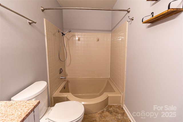 4814 Spring Lake Dr E, Charlotte, NC 28212 - bathroom featuring toilet, washtub / shower combination, stone finish floor, and vanity
