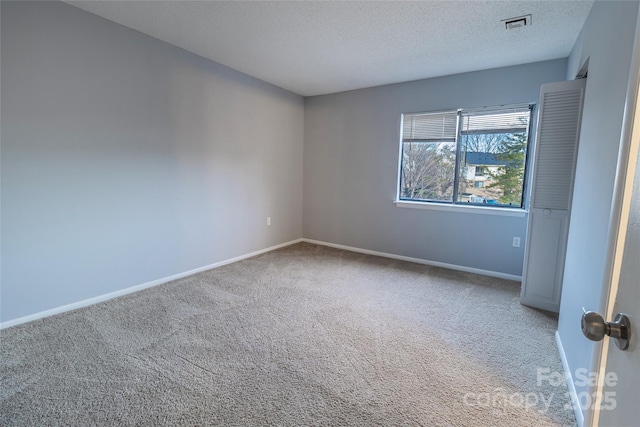 4814 Spring Lake Dr E, Charlotte, NC 28212 - empty room featuring carpet floors, visible vents, a textured ceiling, and baseboards