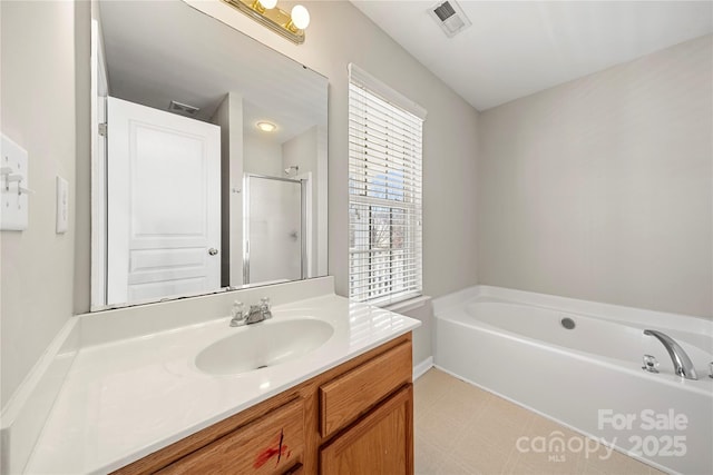 full bathroom with visible vents, a shower stall, vanity, and a bath